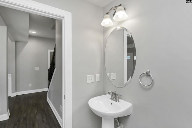 bathroom featuring a sink, baseboards, and wood finished floors