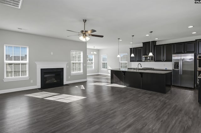 kitchen featuring dark wood-style floors, stainless steel appliances, a sink, and visible vents