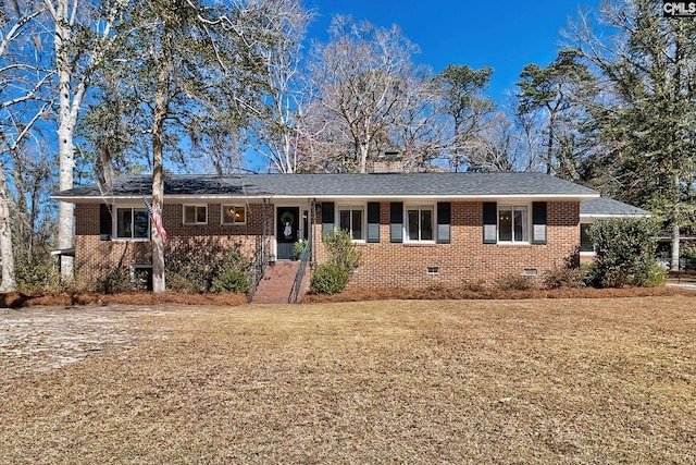 single story home with a front yard, crawl space, brick siding, and roof with shingles