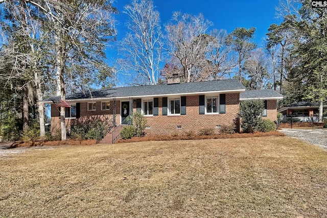 ranch-style home featuring a shingled roof, crawl space, brick siding, and a front lawn