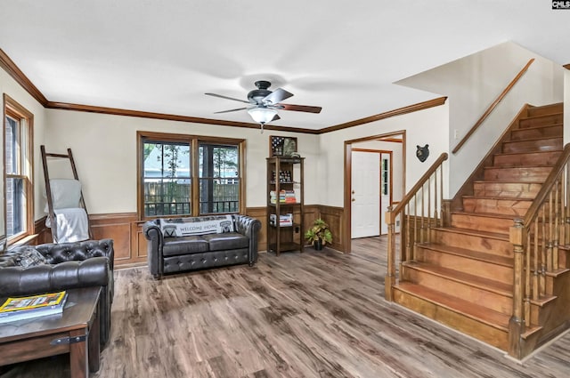 living room featuring ceiling fan, stairway, wood finished floors, and wainscoting