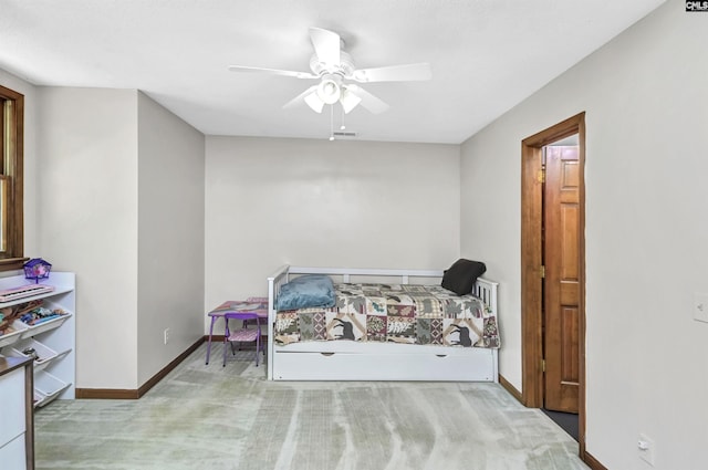 carpeted bedroom with visible vents, baseboards, and a ceiling fan