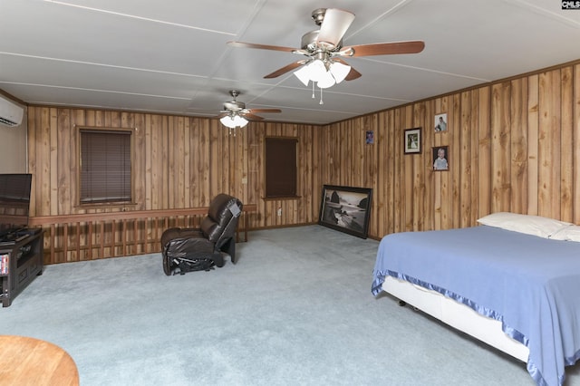 bedroom with a wall mounted AC, ceiling fan, wood walls, and light colored carpet