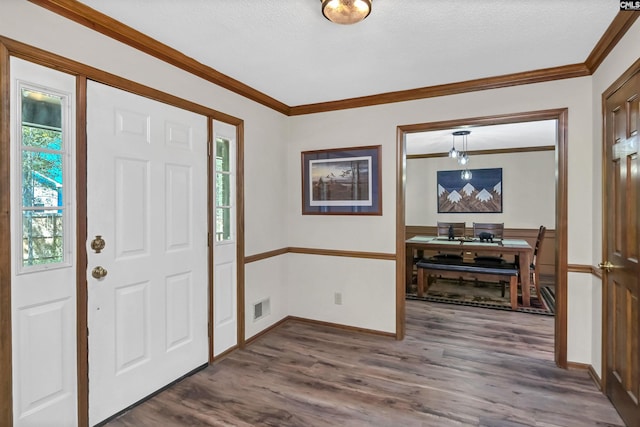 entryway featuring ornamental molding, visible vents, dark wood finished floors, and baseboards