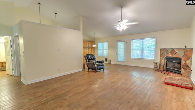 living area with a fireplace, high vaulted ceiling, ceiling fan, baseboards, and wood finished floors