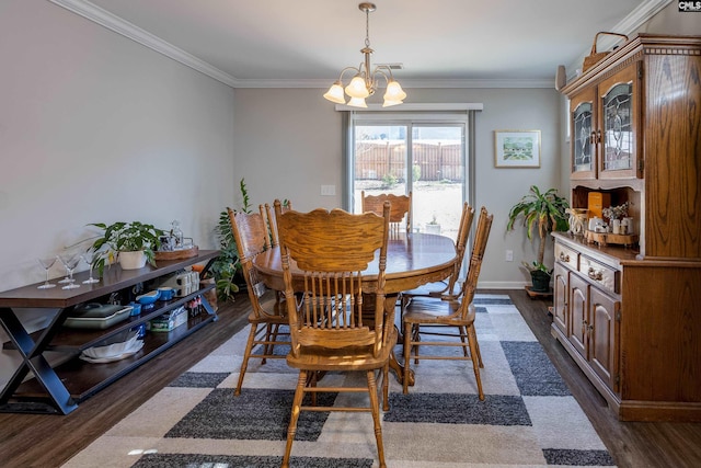 dining area with a notable chandelier, crown molding, baseboards, and dark wood-style flooring