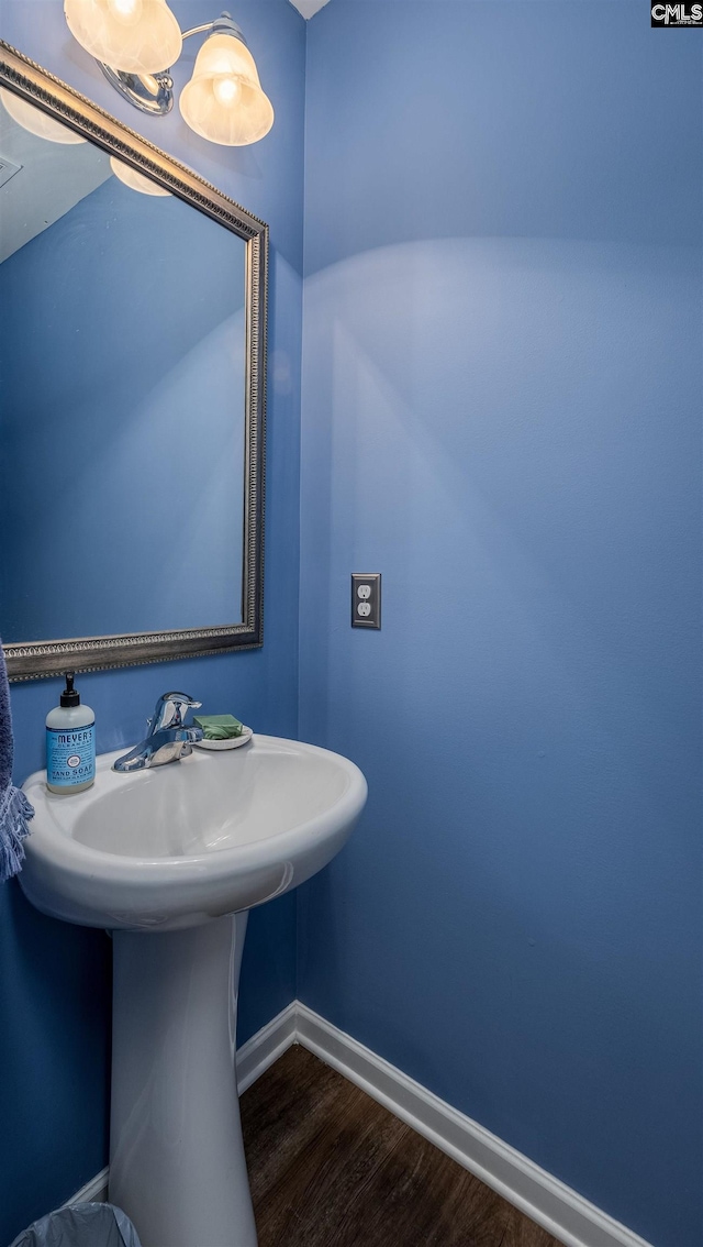 bathroom with baseboards and wood finished floors