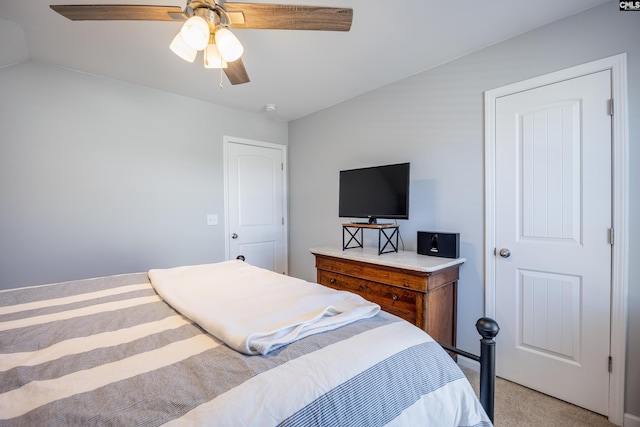 bedroom with a ceiling fan, lofted ceiling, and light colored carpet