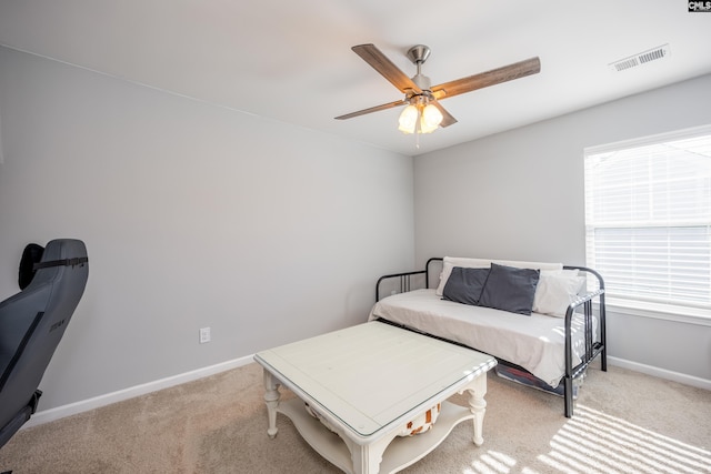 bedroom with light carpet, baseboards, visible vents, and ceiling fan