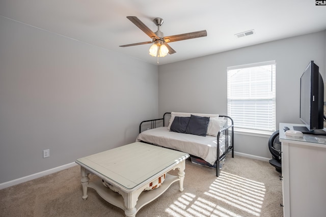 bedroom with baseboards, visible vents, a ceiling fan, and light colored carpet