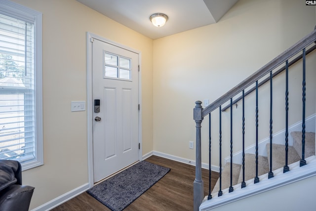 foyer featuring stairway, baseboards, and wood finished floors