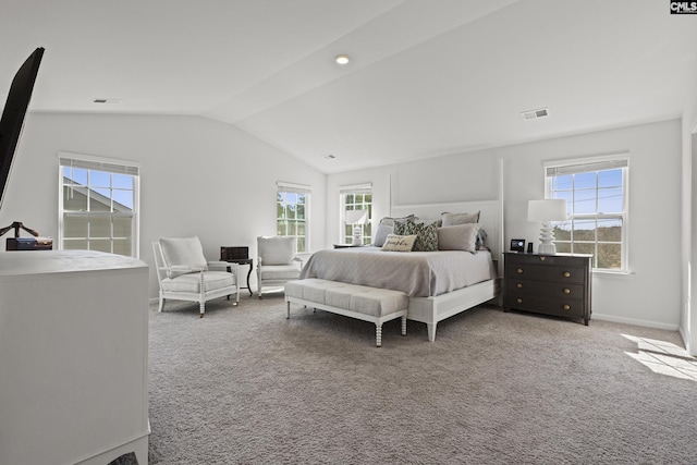 carpeted bedroom with lofted ceiling, visible vents, and multiple windows