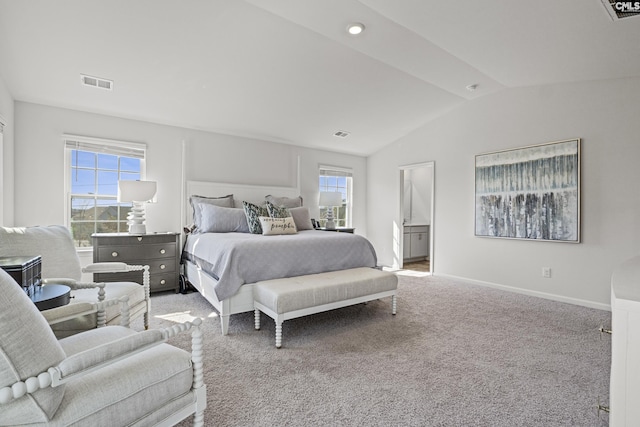 carpeted bedroom with vaulted ceiling, connected bathroom, visible vents, and baseboards