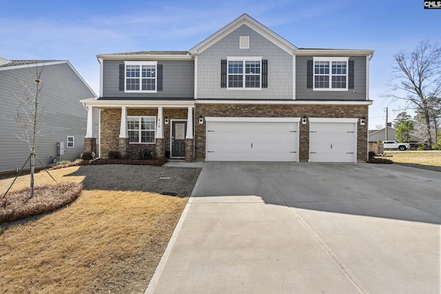 craftsman inspired home featuring a garage, driveway, and a porch