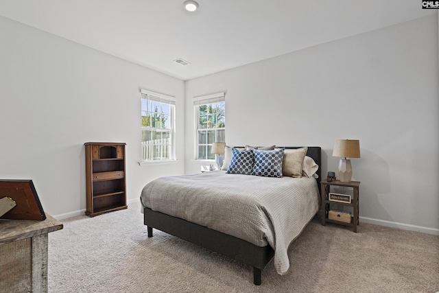 bedroom featuring carpet floors, visible vents, and baseboards