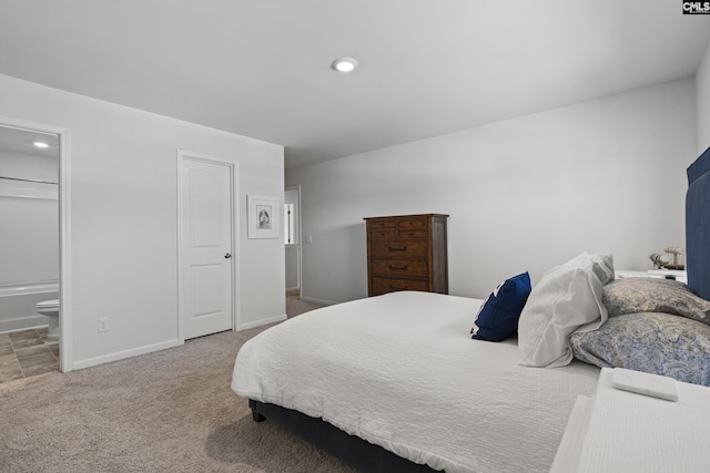 carpeted bedroom with baseboards, ensuite bathroom, and recessed lighting