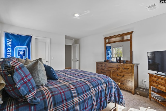 bedroom with visible vents and light colored carpet