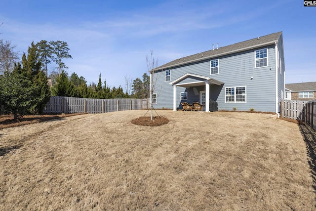 back of property featuring a fenced backyard