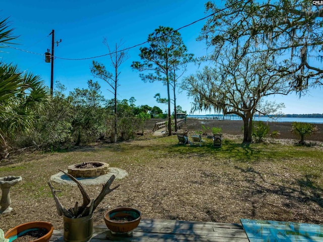 view of yard with a fire pit