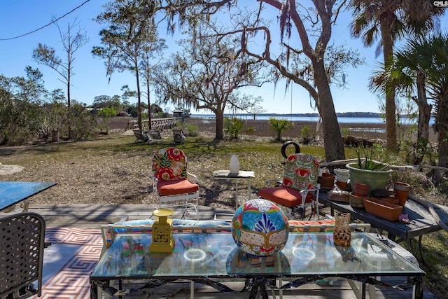 view of patio with outdoor dining space and a water view