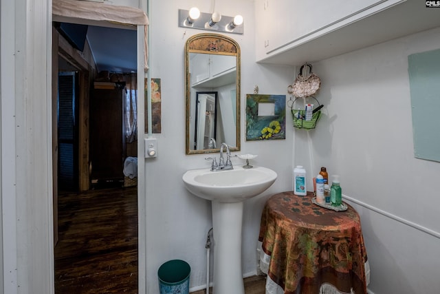 bathroom with a sink and wood finished floors