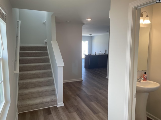 stairway featuring baseboards and wood finished floors