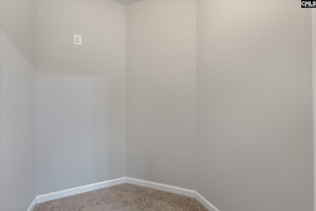 carpeted spare room featuring baseboards