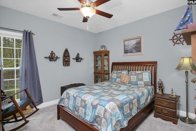 carpeted bedroom featuring ceiling fan, visible vents, and baseboards