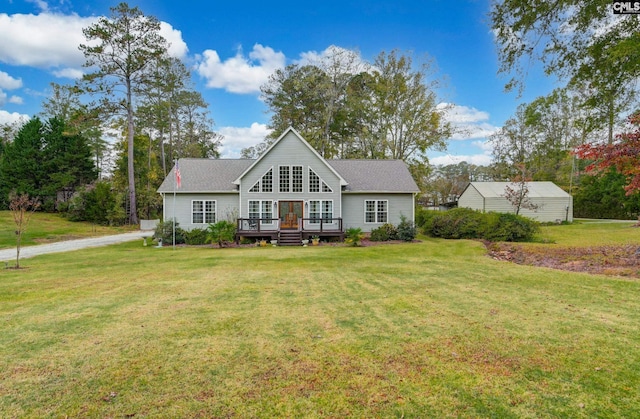 view of front facade with a front yard and a wooden deck