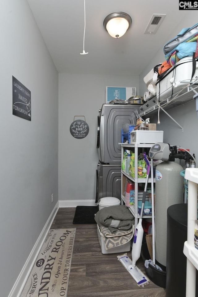 interior space with stacked washing maching and dryer and visible vents