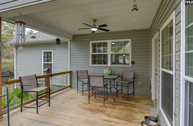 wooden deck featuring ceiling fan and outdoor dining space