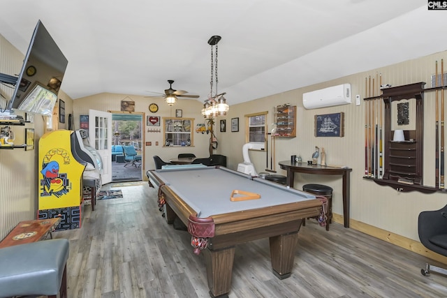 rec room featuring a wall unit AC, ceiling fan, wood finished floors, and lofted ceiling