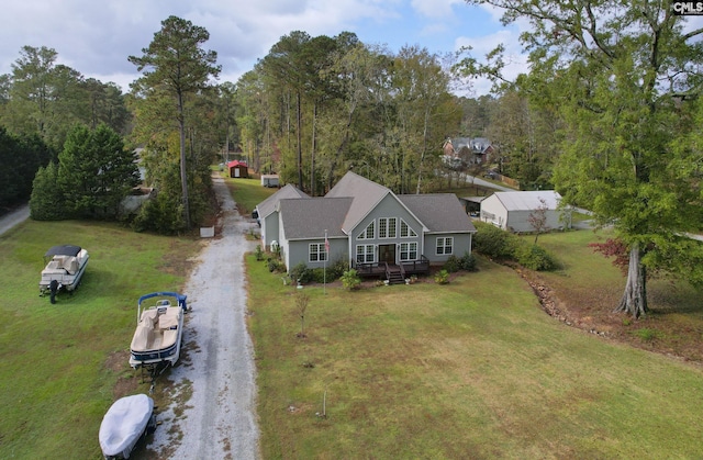 bird's eye view with a wooded view