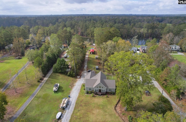 bird's eye view with a wooded view