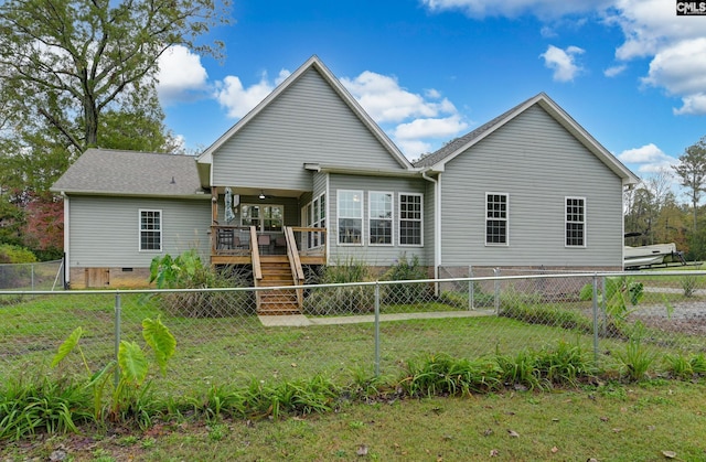 rear view of house with a lawn, crawl space, a deck, a fenced backyard, and stairs