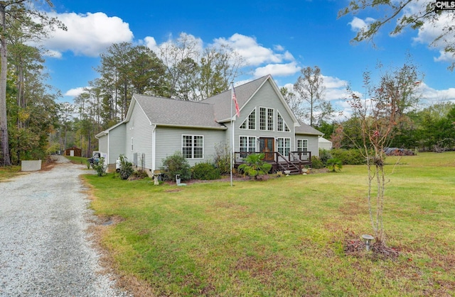 view of front of property featuring driveway, crawl space, a front lawn, and a wooden deck