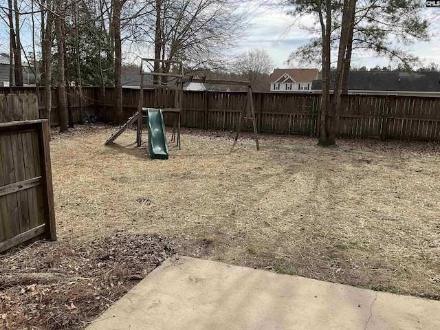 view of yard with a playground and a fenced backyard