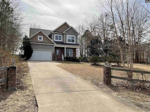 craftsman house featuring brick siding, concrete driveway, a front yard, fence, and a garage