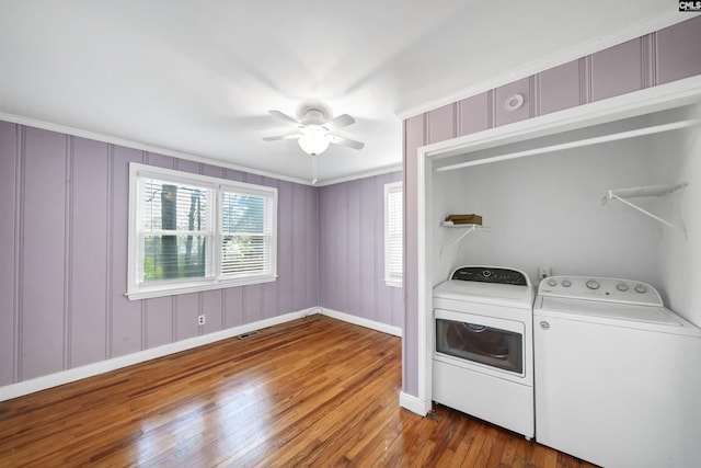 laundry room with laundry area, visible vents, a ceiling fan, wood-type flooring, and washing machine and clothes dryer