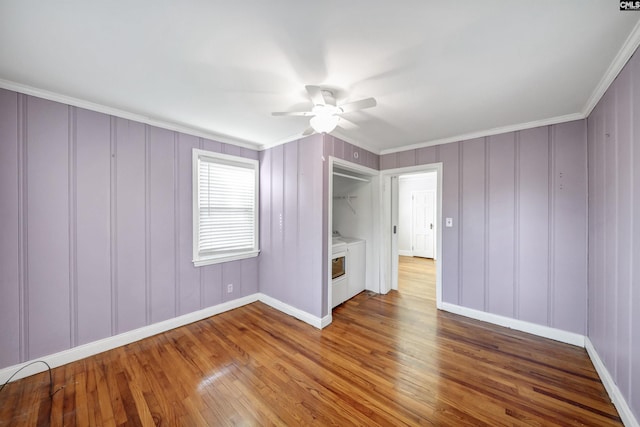 unfurnished bedroom featuring ceiling fan, ornamental molding, wood finished floors, and baseboards