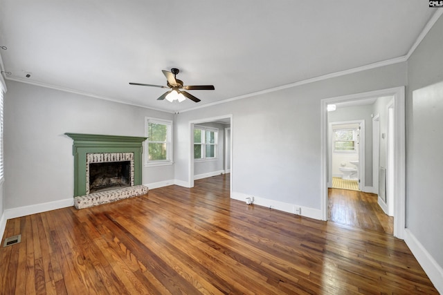 unfurnished living room featuring hardwood / wood-style flooring, a fireplace, a ceiling fan, visible vents, and baseboards