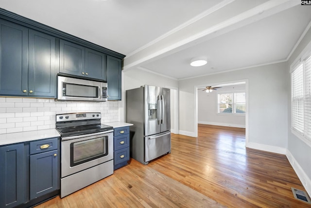 kitchen featuring light wood-style flooring, visible vents, light countertops, appliances with stainless steel finishes, and backsplash