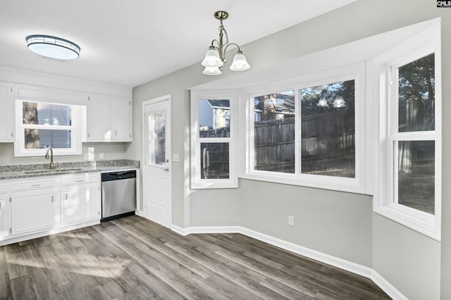 kitchen with a sink, a healthy amount of sunlight, white cabinets, and stainless steel dishwasher