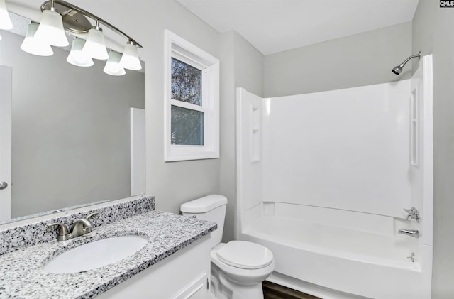 bathroom with toilet, washtub / shower combination, and vanity