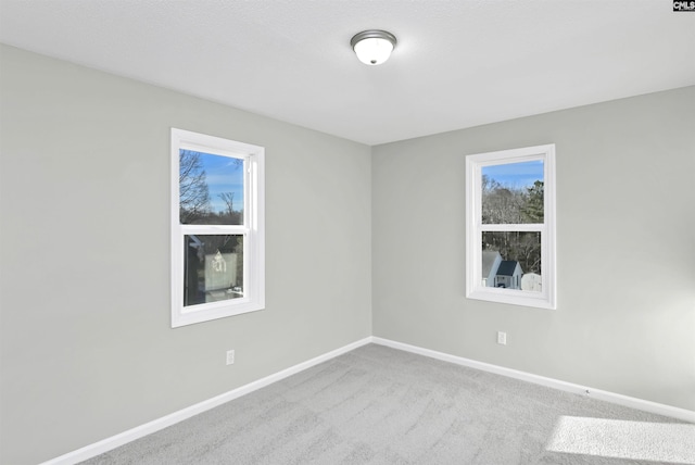 empty room with carpet floors and baseboards