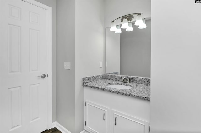 bathroom with vanity and baseboards