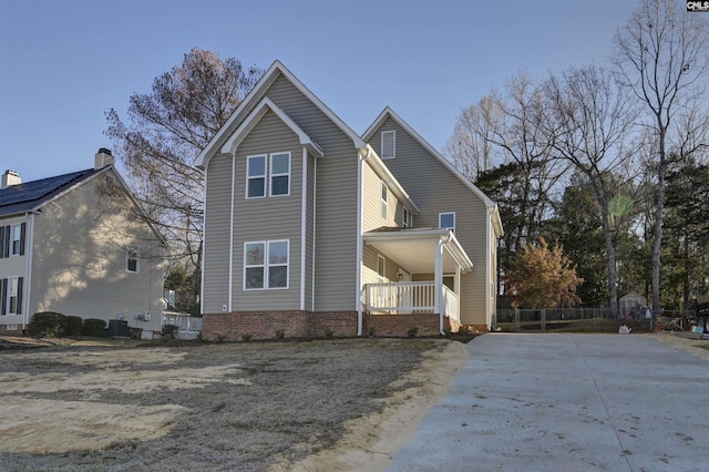 view of side of property with covered porch