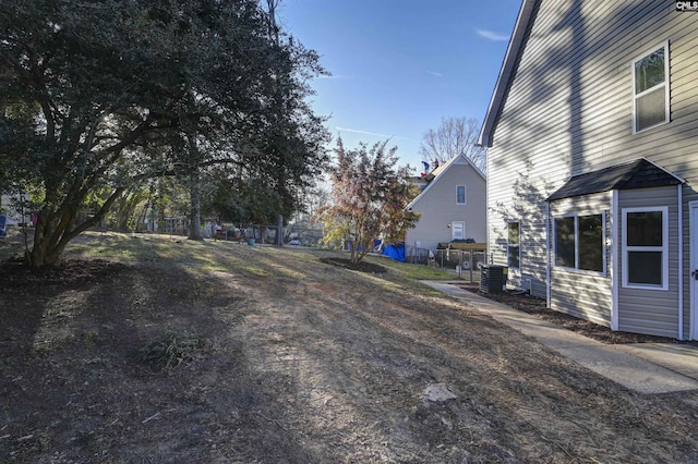 view of yard with cooling unit and fence