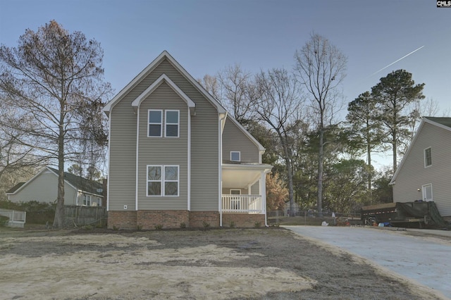 exterior space featuring a porch and fence