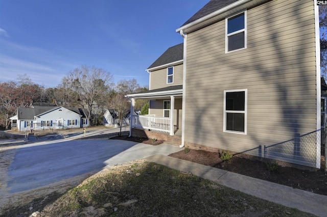 view of side of home with covered porch